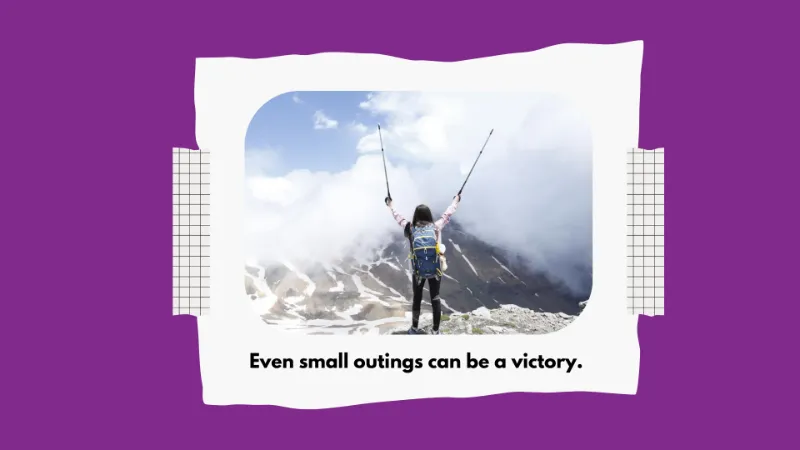 A person on top of a mountain with there walking sticks in the air.