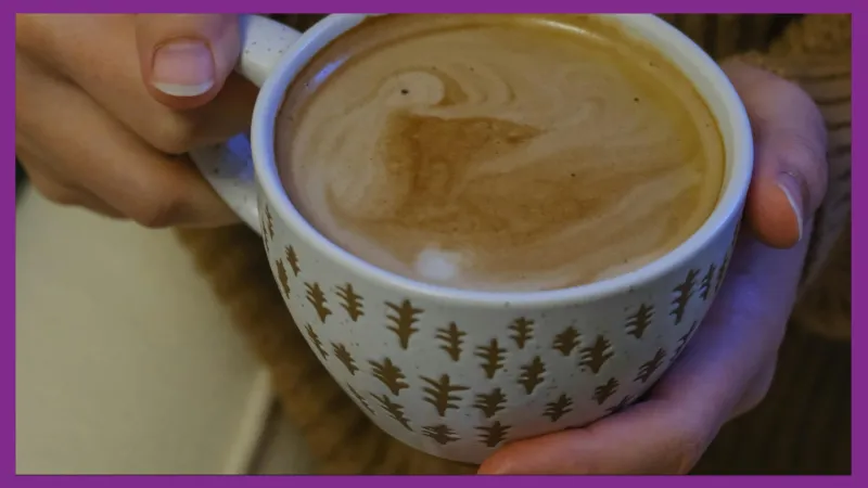 Hands gently holding a mug of tea, suggesting a calming daily ritual during anxious moments.